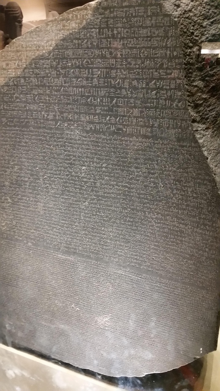 A large, dark stone slab engraved with three sections of ancient text—Egyptian hieroglyphs, Demotic script, and Ancient Greek—the Rosetta Stone unlocked the mystery of translating ancient languages.